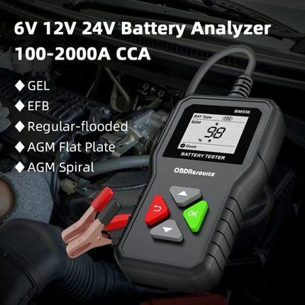 Battery Tester for Routine Vehicle and Home Maintenance - handheld 6V-24V battery analyzer showing 0.98V reading with clamps and car engine background