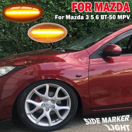 Mazda 2 DY Dynamic LED Fender Side Light Pair Transparent Black shown on red Mazda front fender with illuminated amber LEDs