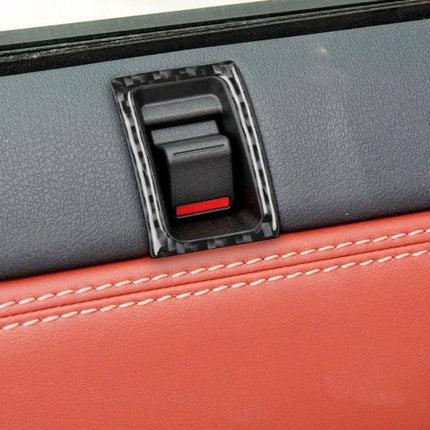 Set of 2 Carbon Fiber Door Lock Decorative Stickers for Nissan GTR R35 installed on black and red door panel close-up