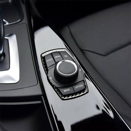 Carbon Fiber Multimedia Frame Sticker for BMW Vehicles applied to center console multimedia control, sleek carbon fiber finish enhancing interior
