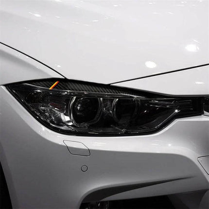 Carbon Fiber Decorative Sticker for Car Lamp Eyebrows in Yellow Red applied to headlight corner, subtle yellow and red carbon fiber trim enhancing car appearance