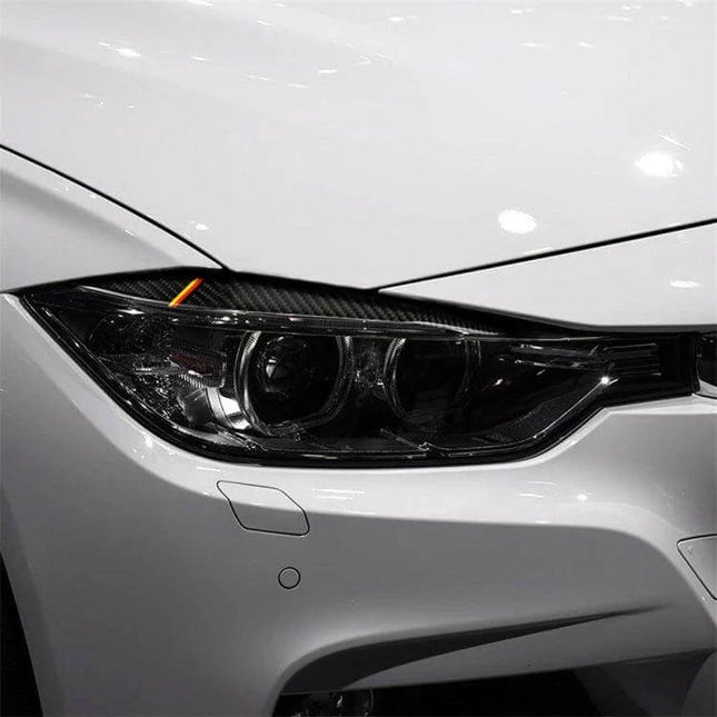 Carbon Fiber Decorative Sticker for Car Lamp Eyebrows in Yellow Red applied to headlight corner, subtle yellow and red carbon fiber trim enhancing car appearance