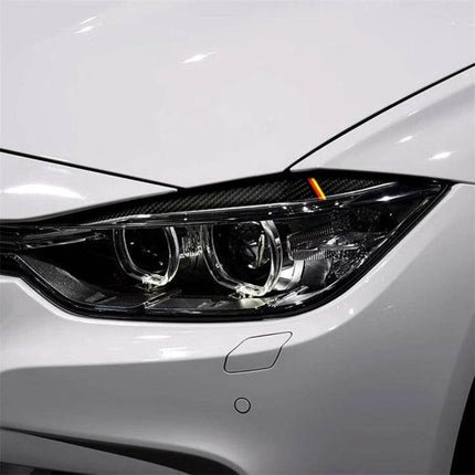 Carbon Fiber Decorative Sticker for Car Lamp Eyebrows in Yellow Red on white car headlight showing subtle carbon fiber trim accent