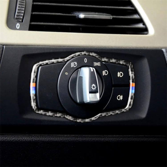 Carbon Fiber Decorative Sticker for BMW Headlight Switches — close-up of carbon-fiber trim applied around BMW headlight control knob