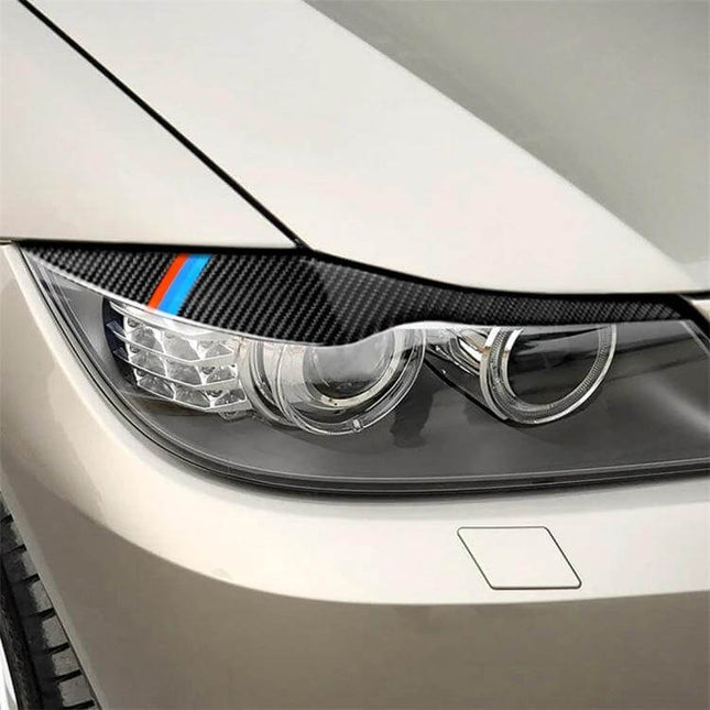 Carbon Fiber Lamp Eyebrow Decorative Sticker for BMW, Three Colors on white BMW headlight showing carbon fiber finish and colored stripe