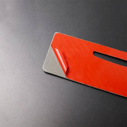 Carbon Fiber Rear Air Vent Decorative Sticker for BMW Vehicles - close-up of red adhesive backing peeled on carbon fiber sticker