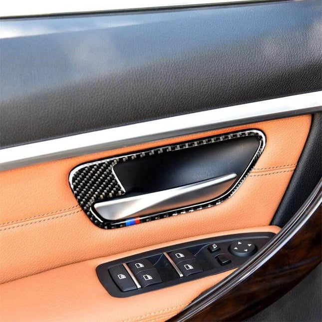 Carbon Fiber Three-Color Decorative Sticker for BMW Doors installed on tan leather BMW door panel around interior handle