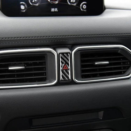 Carbon Fiber Warning Light Decorative Sticker for Mazda CX-5 installed on dashboard between air vents, carbon fiber pattern with red hazard icon