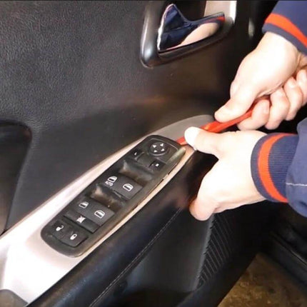 Dodge/Chrysler Window Master Control Switch Replacement being installed on driver door panel, showing prying tool and switch assembly