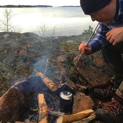Camping Survival Fire Tube Telescopic 8 Section Blowpipe used to blow a campfire safely while heating a kettle by a lakeside