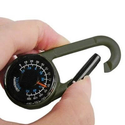 Carabiner Key Compass and Thermometer for Hiking Gear clipped to backpack loop showing compass and thermometer in hand
