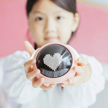 Cartoon Cmart Alarm Clock For Kids With Night Light showing pink round clock with pixel heart night light held by child on nightstand