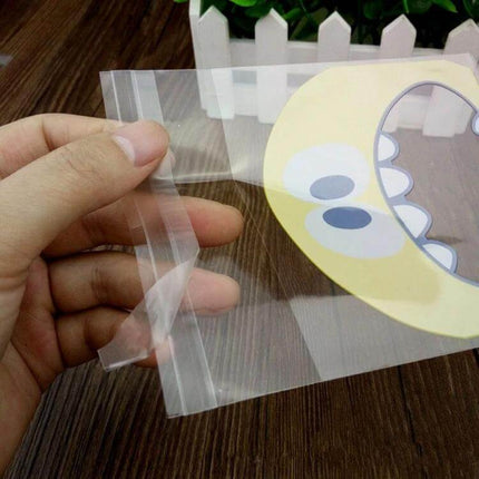 Cartoon Monster OPP Packaging Bags 7x7cm and 10x10cm clear OPP bag with gravure-printed yellow cartoon monster face for snacks and party favors
