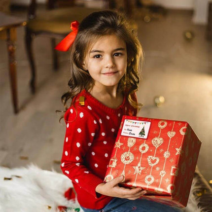 Christmas Gift Bag Stickers Set 72 Pieces For Sealing Packages - child holding wrapped Christmas present with red sweater and bow