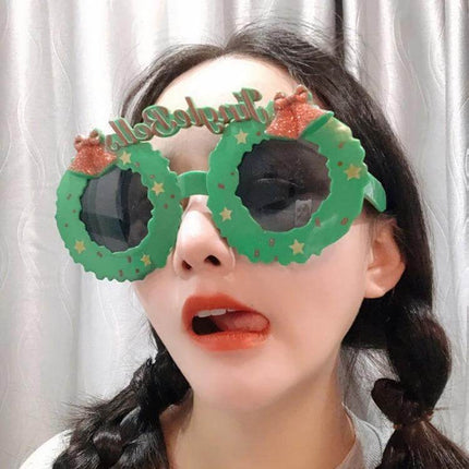 Christmas Hair Clip For Festive Everyday Wear Deer And Bell Design on model wearing green wreath-style novelty glasses for holiday look