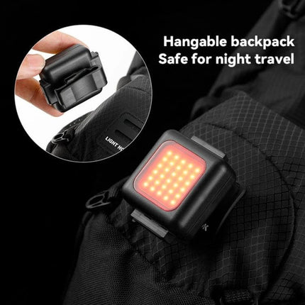 COB Lamp Beads Mini Mountain Bike Light Waterproof shown mounted on backpack with strap base and red COB LED array for night travel