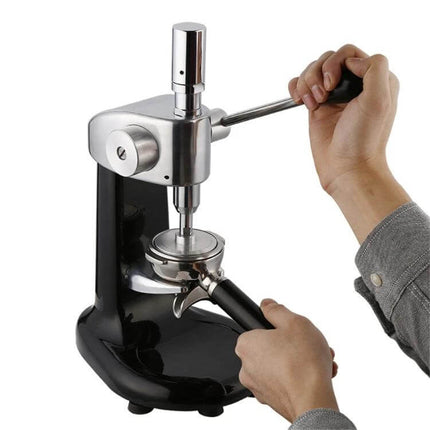 Coffee Tamper Handmade Stainless Steel For Espresso being used with a lever press for consistent tamping in a small cafe or home setup