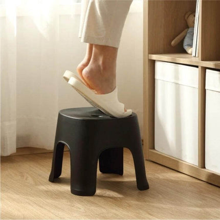 Row Stool for Bathroom and Living Use, Adult and Child Sizes - compact black PVC step stool shown with adult foot stepping on it, stackable, sink and shelf reach