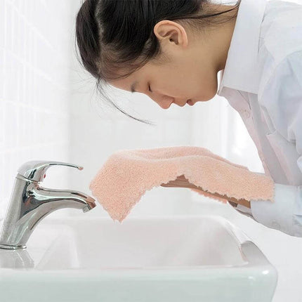 Coral Fleece Face Towel 30x30cm for Everyday Use at Home - woman drying face with soft pink coral fleece towel at sink