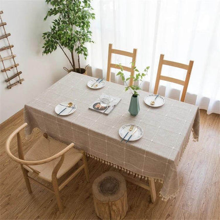 Cotton Linen Square Lattice Tablecloth With Tassels 140x200 cm for Dining on simple wooden dining table with plates and vase