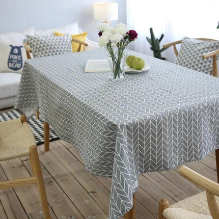 Cotton Linen Tablecloth For Dining Tables With Gray Arrow Geometric Pattern draped on wooden dining table with vase and fruit