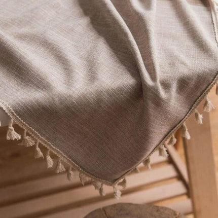 Cotton Linen Tassels Dining Tablecloth Rectangle 140x180cm draped on wooden chair with natural tassel edge