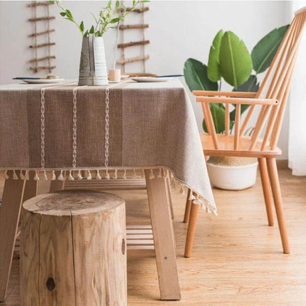 Cotton Linen Tassels Dining Tablecloth Rectangle 140x180cm on wooden table with tassel trim in cozy dining room setting