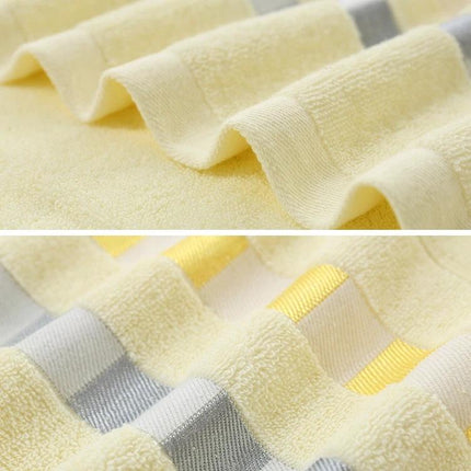 Cotton Plain Bath Towel 140x70 For Daily Bathroom Use - Soft yellow cotton towel with textured weave and subtle striped edge