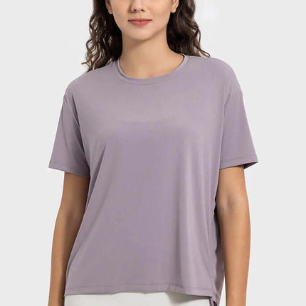 Women's Short Sleeve Side Drawstring Yoga Top Cotton Blend in lead powder color on model, hip-length pullover with side drawstring