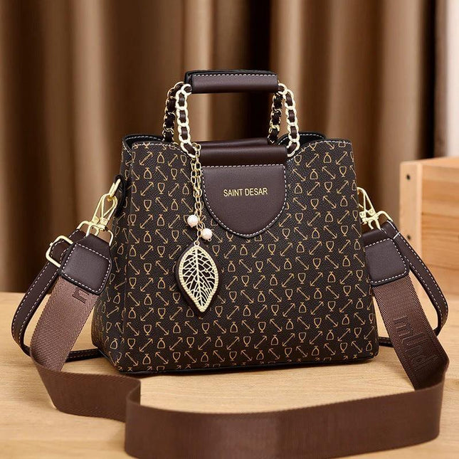 Women's Vintage Printed Bucket Handbag Small Brown compact PU bucket bag with gold chain handles and leaf charm