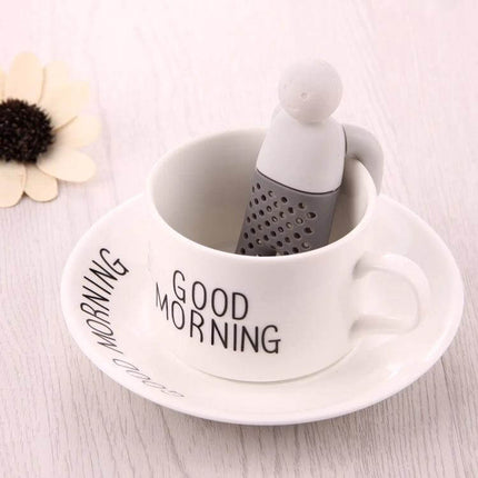 Cute Mr Tea Infuser Compact Silicone Tea Strainer For Everyday Tea - gray silicone infuser standing in white "Good Morning" teacup