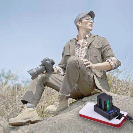 Portable USB Battery Charger for Sony NP-FZ100 Cameras shown charging a camera battery from a power bank while photographer shoots outdoors