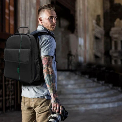 Indepman Waterproof Outdoor Camera Backpack for Sports and Travel shown on tattooed photographer carrying camera in urban ruin, waterproof nylon protection