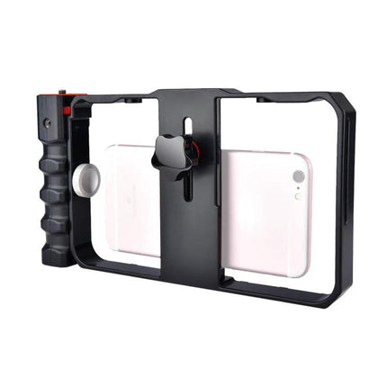Handheld Cage for Smartphone Filming in Daily Life – black aluminum cage with side grip holding a pink smartphone for stable vlogging and casual video capture