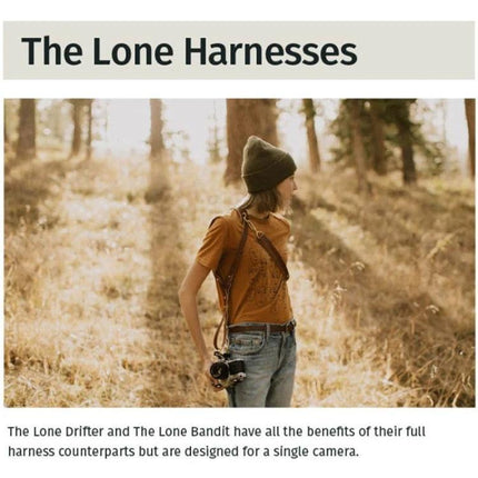 Adjustable Anti-Slip Leather Shoulder Harness for DSLR Cameras worn by photographer in outdoor forest setting, hands-free camera carry, neck strain relief