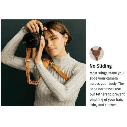 Adjustable Anti-Slip Leather Shoulder Harness for DSLR Cameras worn by photographer for hands-free, no-sliding camera carry and quick access