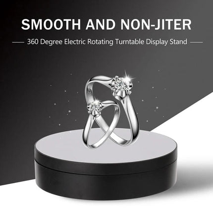 Compact 360 Degree Rotating Display Turntable for Photography and Video showing a ring on a smooth black rotating display