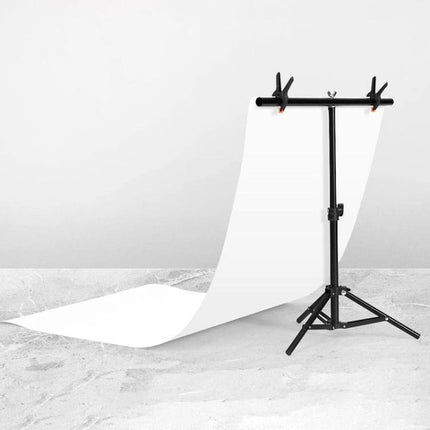 T-Shape Adjustable Photo Background Support Stand for Studios with sturdy metal frame holding white backdrop for portrait and product photography