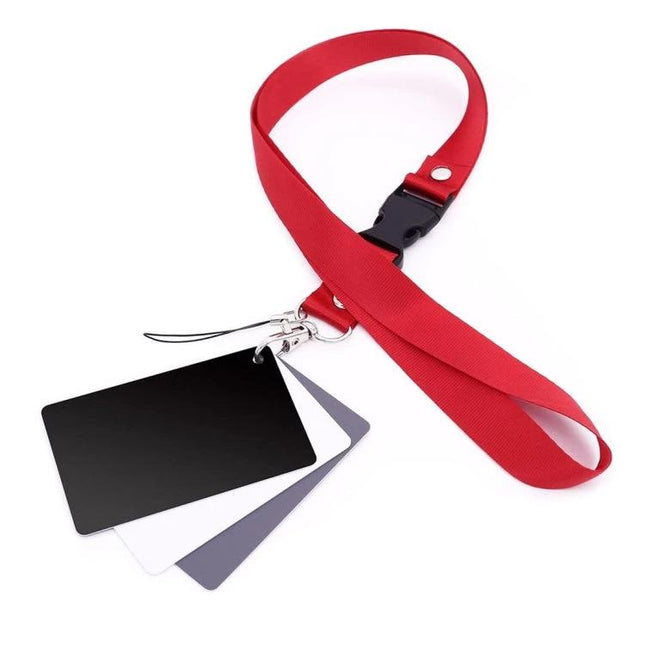 Digital Gray Card Set for Camera White Balance and Color Correction showing gray, white, black reference cards on red lanyard