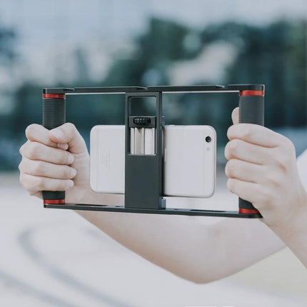 YELANGU Cage for Smartphone Video Recording on the Go - hands holding lightweight smartphone video cage with dual handles and tripod mount