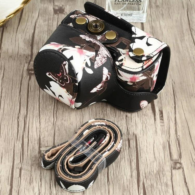Flower Pattern PU Leather Protective Case for Sony Cameras with matching strap on wood surface