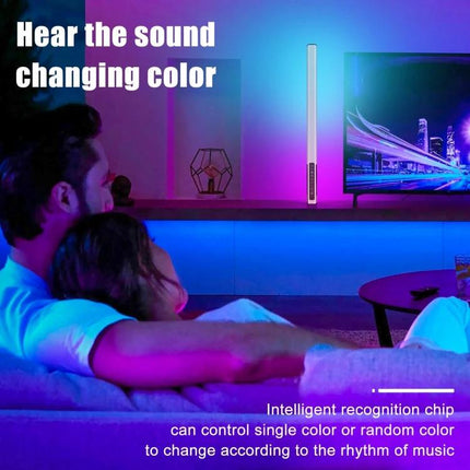 Couple watching TV with ambient color from a LUXCeO 85cm RGB LED Stick Light for Video and Photography creating music-reactive mood lighting