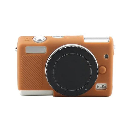 Soft Silicone Protective Case for Canon EOS M100 Camera in tan silicone fitted on camera body, slim non-slip cover protecting controls and lens mount
