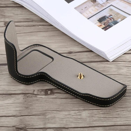 Protective PU Leather Half Case with Thread for Canon Cameras shown in black faux leather with beige interior and tripod screw