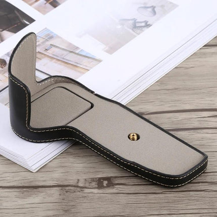 Classic PU Leather Protective Half Case for Canon DSLRs shown open on a tabletop, black exterior with beige interior and gold tripod screw