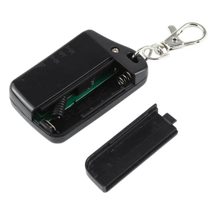 Wireless Anti-Lost Alarm for Tracking Everyday Items black transmitter keychain with open battery compartment and detached cover