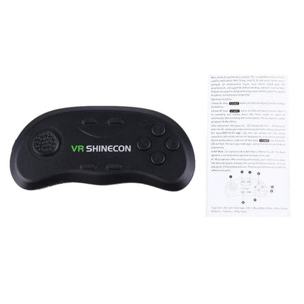 Shinecon Virtual Reality Glasses with Bluetooth Controller for Games Bluetooth game controller and manual on white background