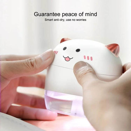 Devil Atomizing Humidifier With Colorful Night Lights compact cute cat design on desk showing hands filling tank and glowing night light