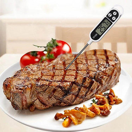 Digital Kitchen Food Thermometer With Stainless Steel Probe inserted in grilled steak on plate, showing digital temperature reading