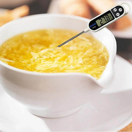 Digital Kitchen Food Thermometer With Stainless Steel Probe measuring soup temperature in a white bowl, 304 stainless steel probe and LCD display